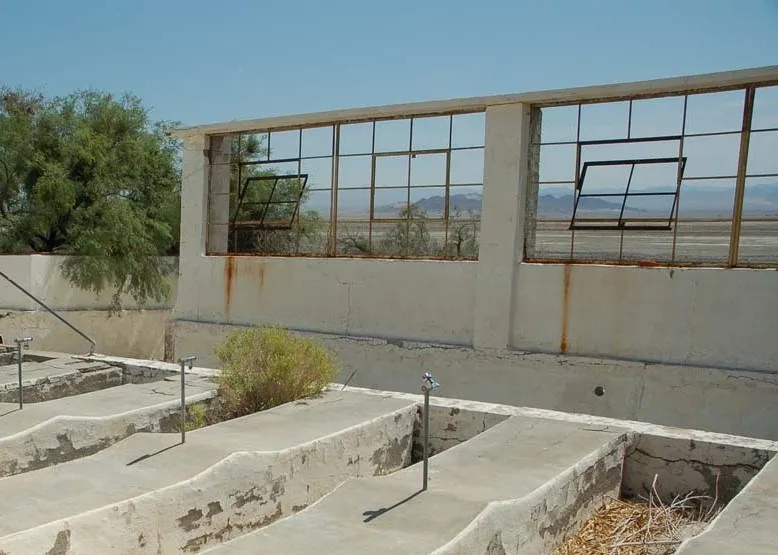 Empty bathtub-sized soaking pools inside the ruined pool house at Zzyzx